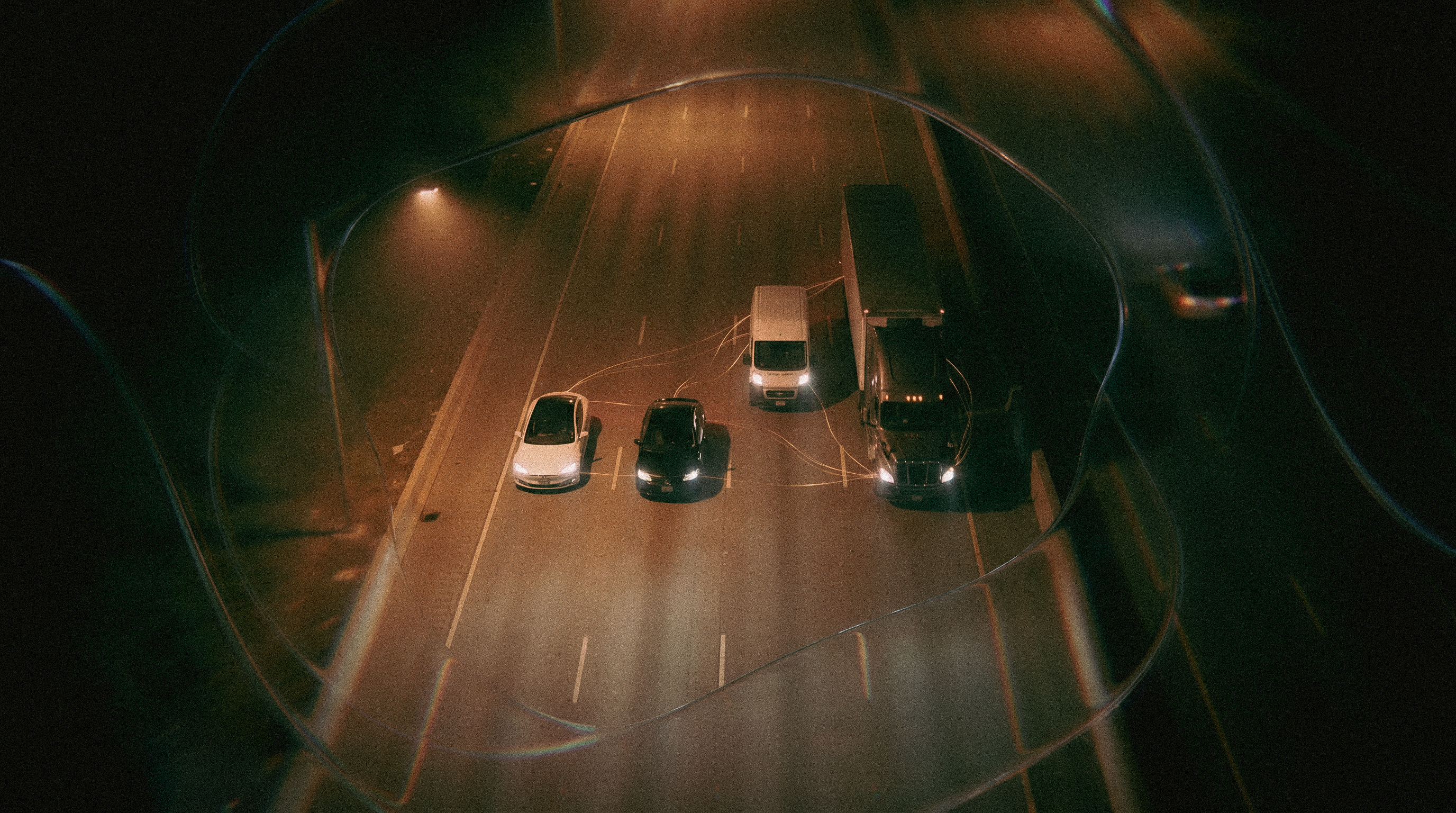 A dark roadway with light trails moving through liquid glass